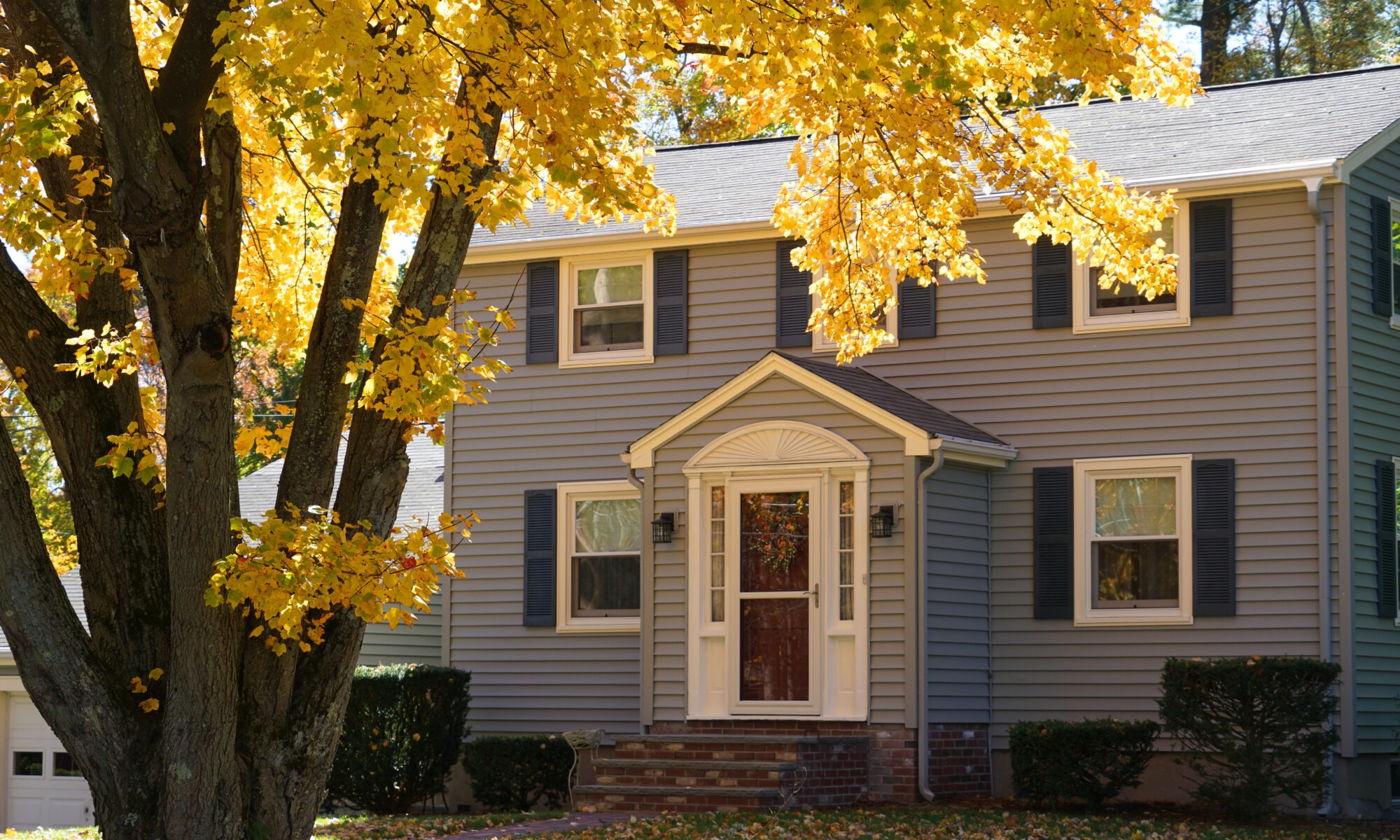 a gray midwestern home in fall