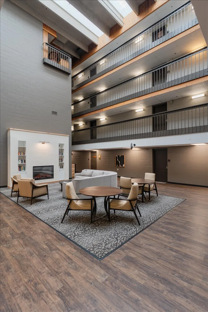 Image of a lobby with chairs and a fireplace